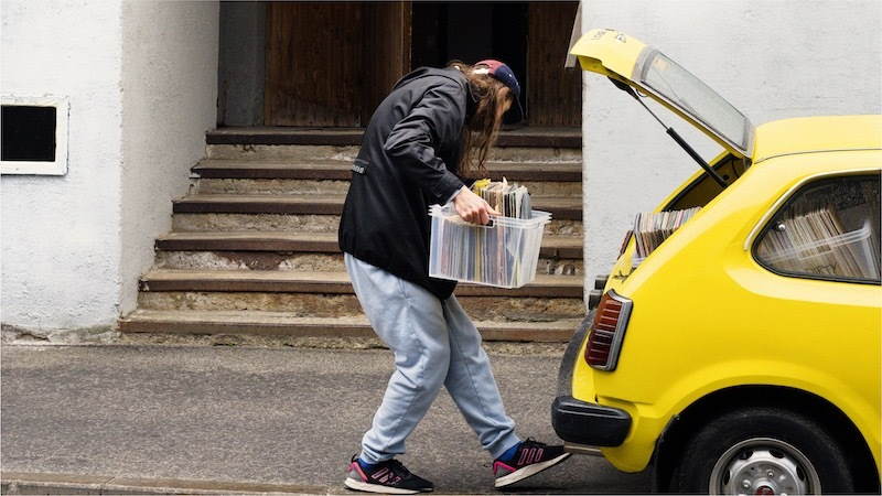 man packing items in car boot